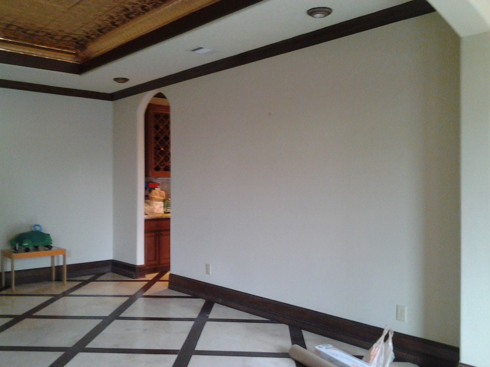 Example of a mid-sized travertine floor enclosed dining room design in Houston with beige walls and no fireplace