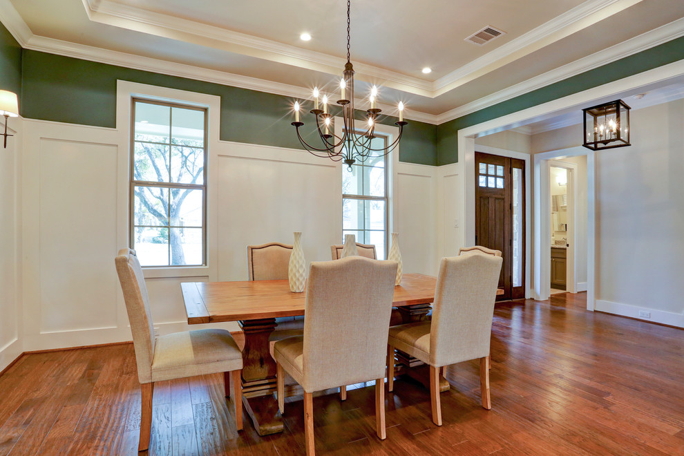 Inspiration for a large craftsman medium tone wood floor enclosed dining room remodel in Houston with blue walls