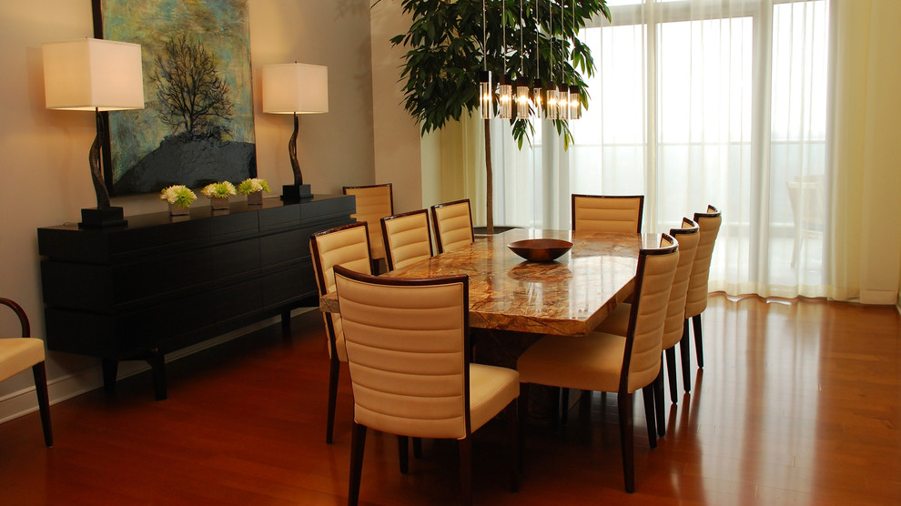Large contemporary open plan dining room in Atlanta with beige walls and medium hardwood flooring.