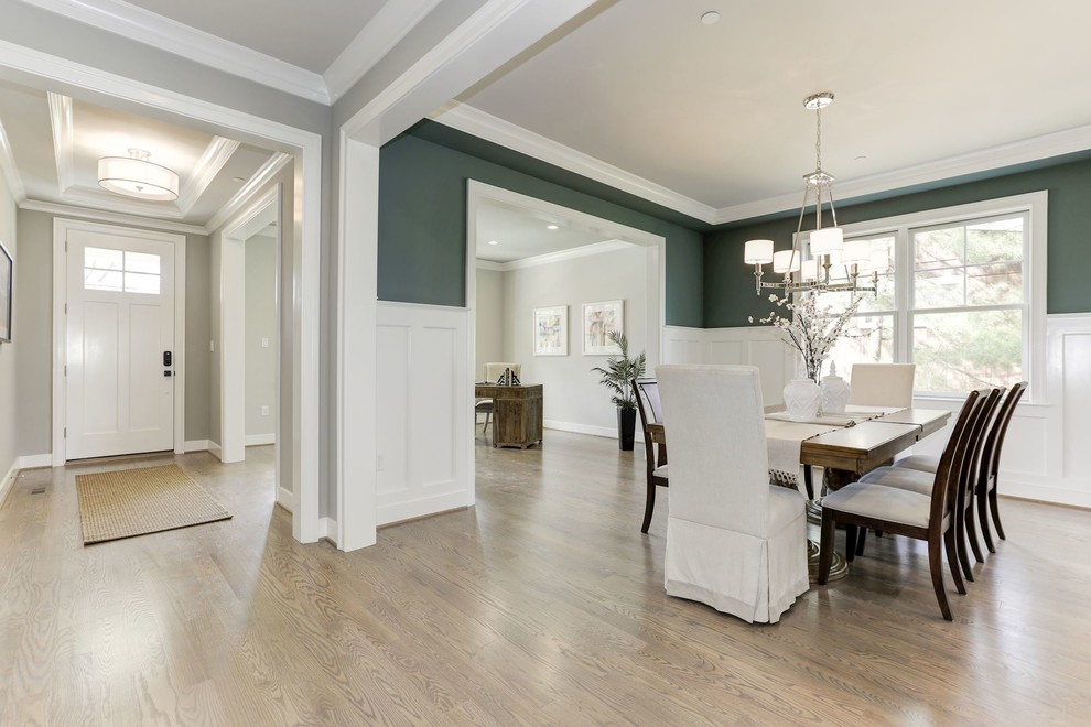 Inspiration for a medium sized traditional enclosed dining room in Other with green walls, light hardwood flooring, no fireplace, brown floors and feature lighting.