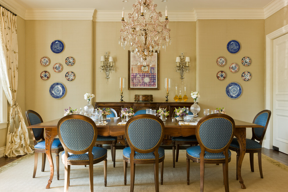 Photo of a classic dining room in DC Metro with yellow walls and dark hardwood flooring.