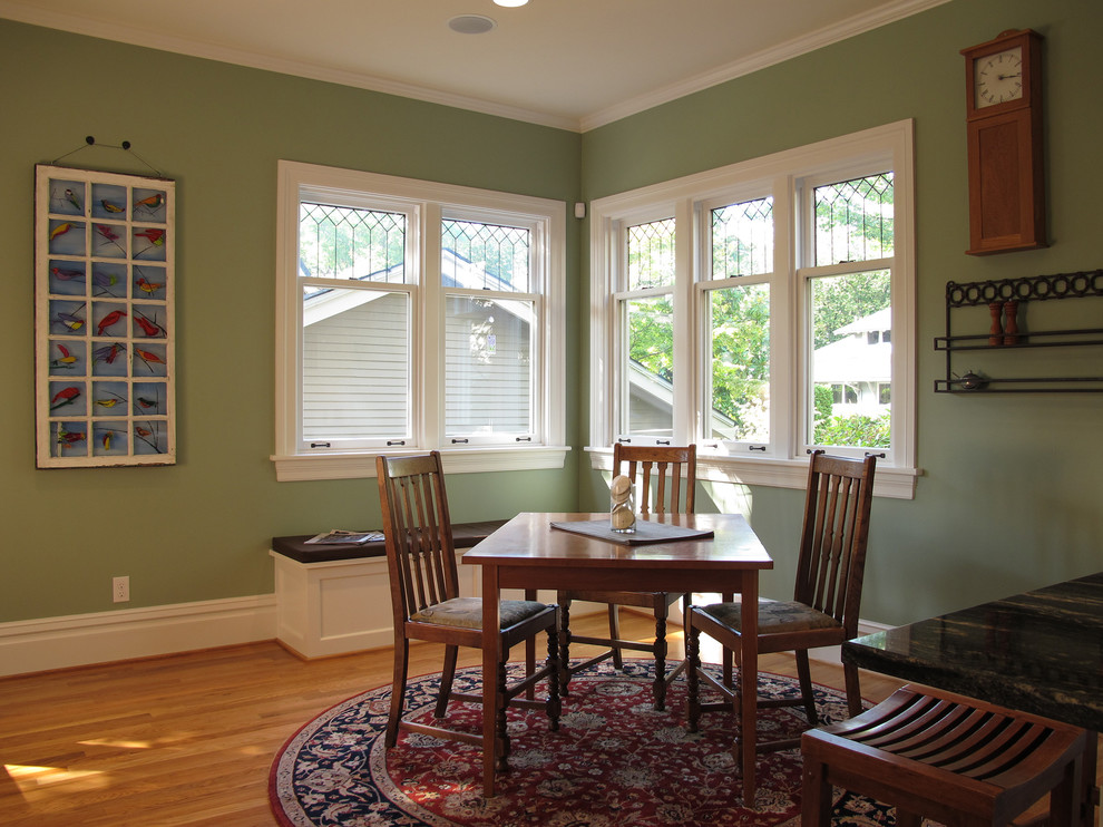 This is an example of a medium sized traditional kitchen/dining room in Seattle with green walls, medium hardwood flooring and no fireplace.