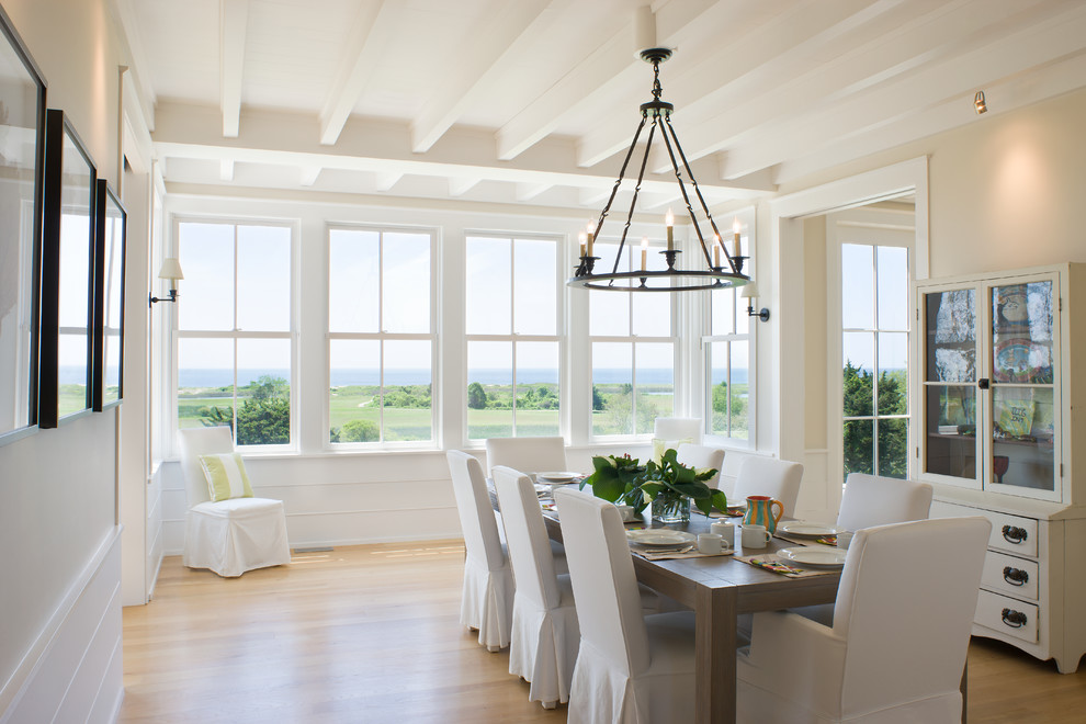 Photo of a rural enclosed dining room in Providence with beige walls and medium hardwood flooring.