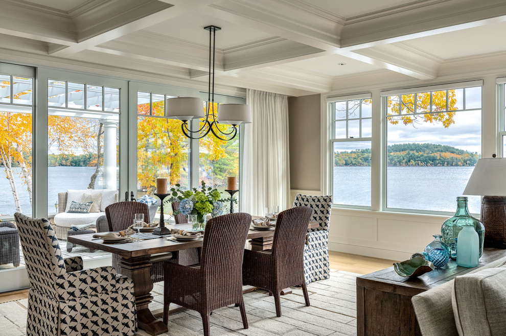 Inspiration for a beach style open plan dining room in Boston with grey walls and light hardwood flooring.