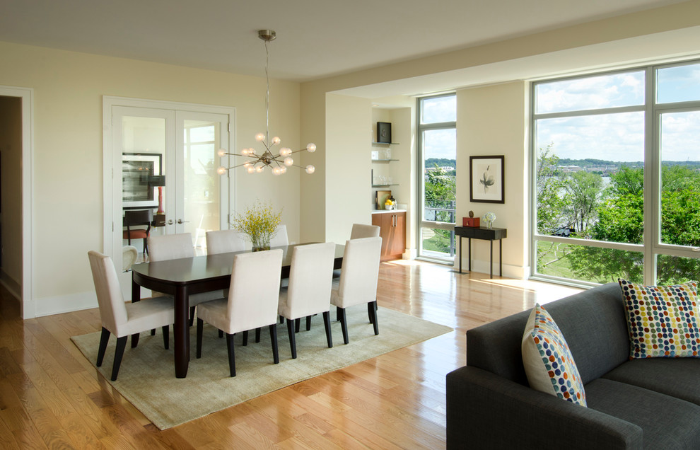 Inspiration for a contemporary open plan dining room in DC Metro with beige walls and medium hardwood flooring.