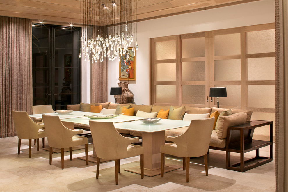 Photo of a large world-inspired dining room in Miami with feature lighting.