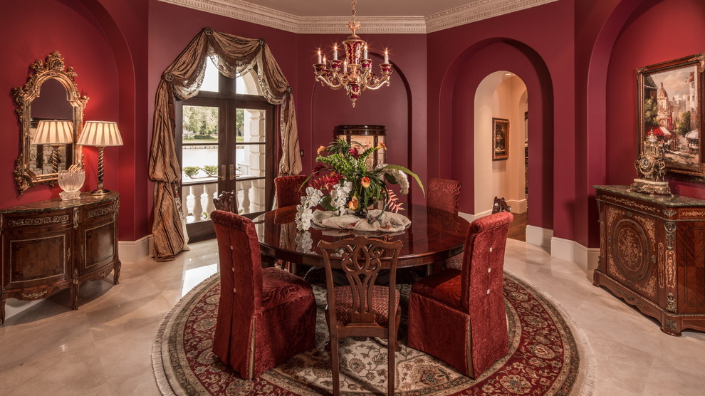 Photo of a large mediterranean enclosed dining room in Houston with red walls and feature lighting.