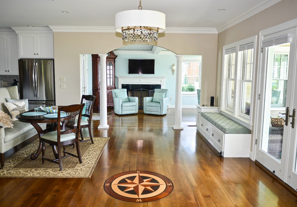 This is an example of a medium sized beach style open plan dining room in Providence with beige walls, dark hardwood flooring, no fireplace and beige floors.
