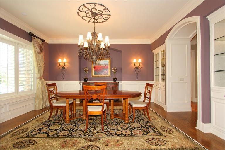 Large classic enclosed dining room in Cincinnati with purple walls, medium hardwood flooring and no fireplace.