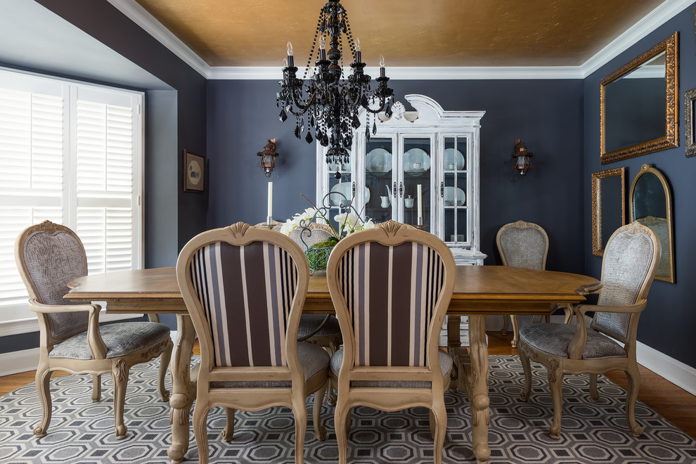 This is an example of a medium sized classic enclosed dining room in St Louis with medium hardwood flooring, blue walls, no fireplace and brown floors.
