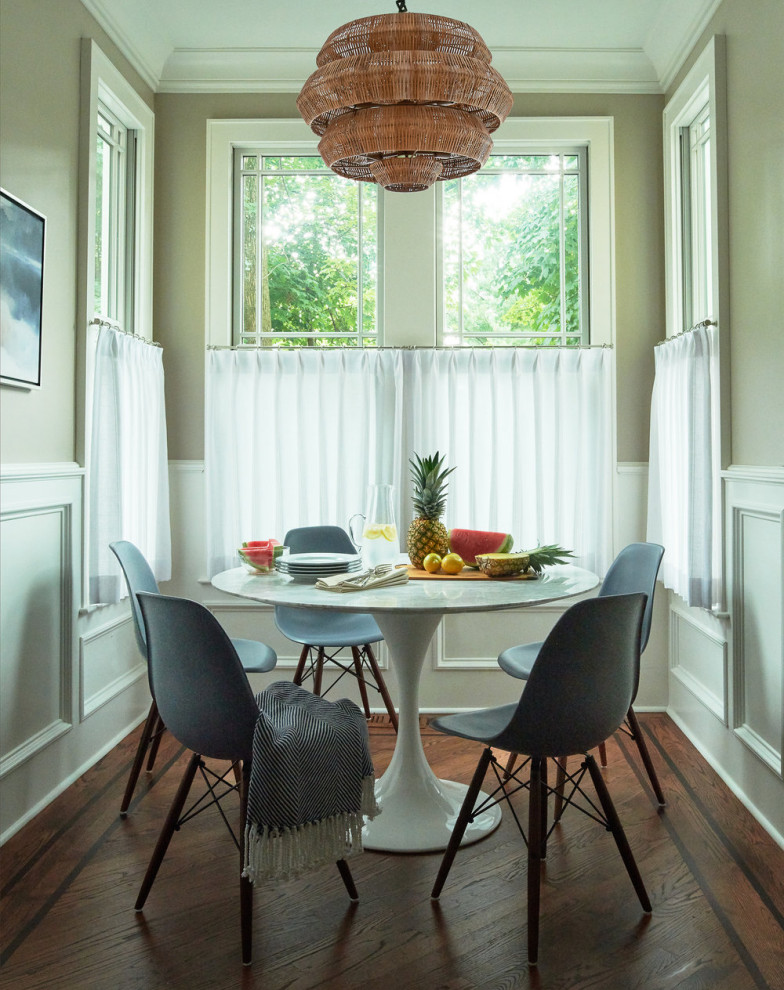 Transitional dark wood floor, brown floor and wainscoting kitchen/dining room combo photo in New York with beige walls