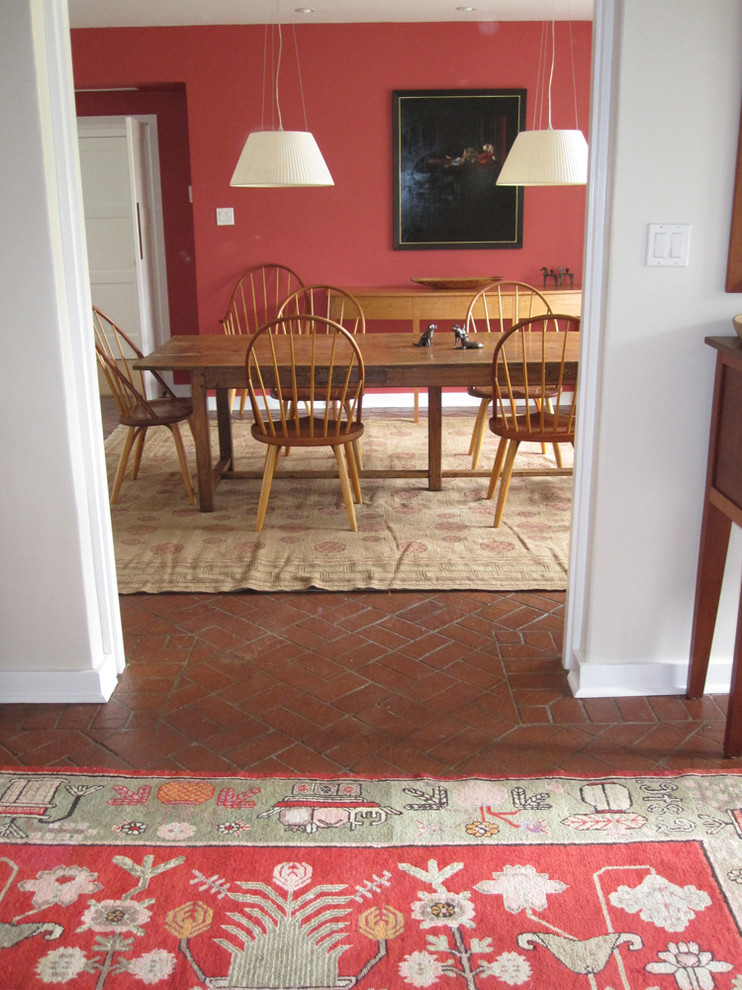 Inspiration for a transitional brick floor dining room remodel in Albuquerque with red walls