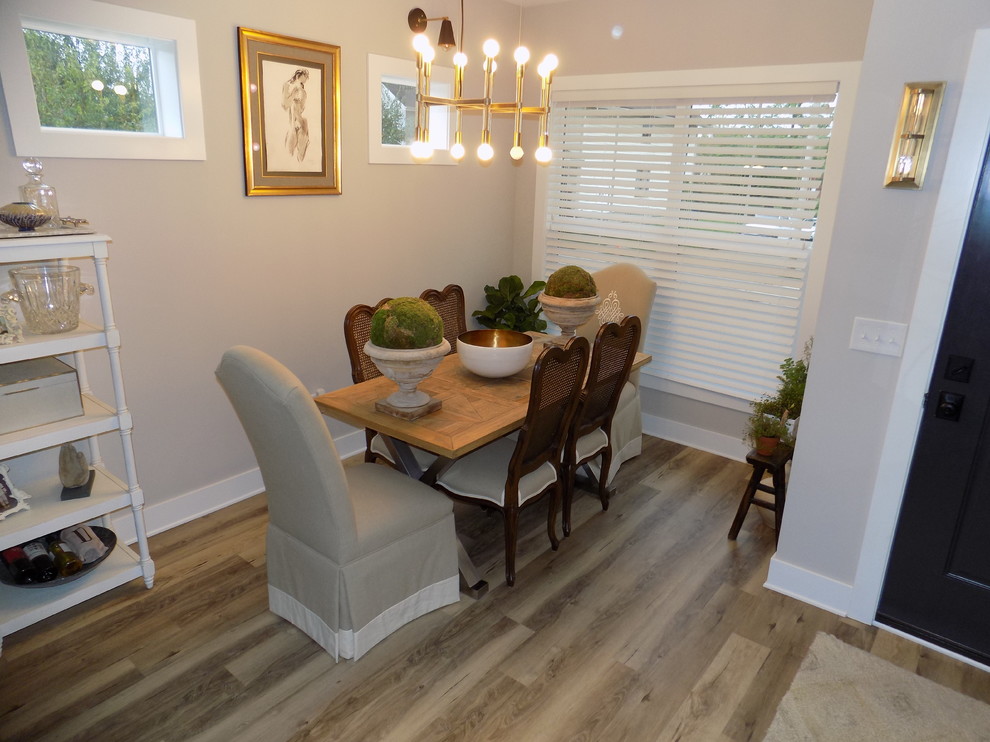 Inspiration for a small traditional open plan dining room in Columbus with grey walls, laminate floors and brown floors.