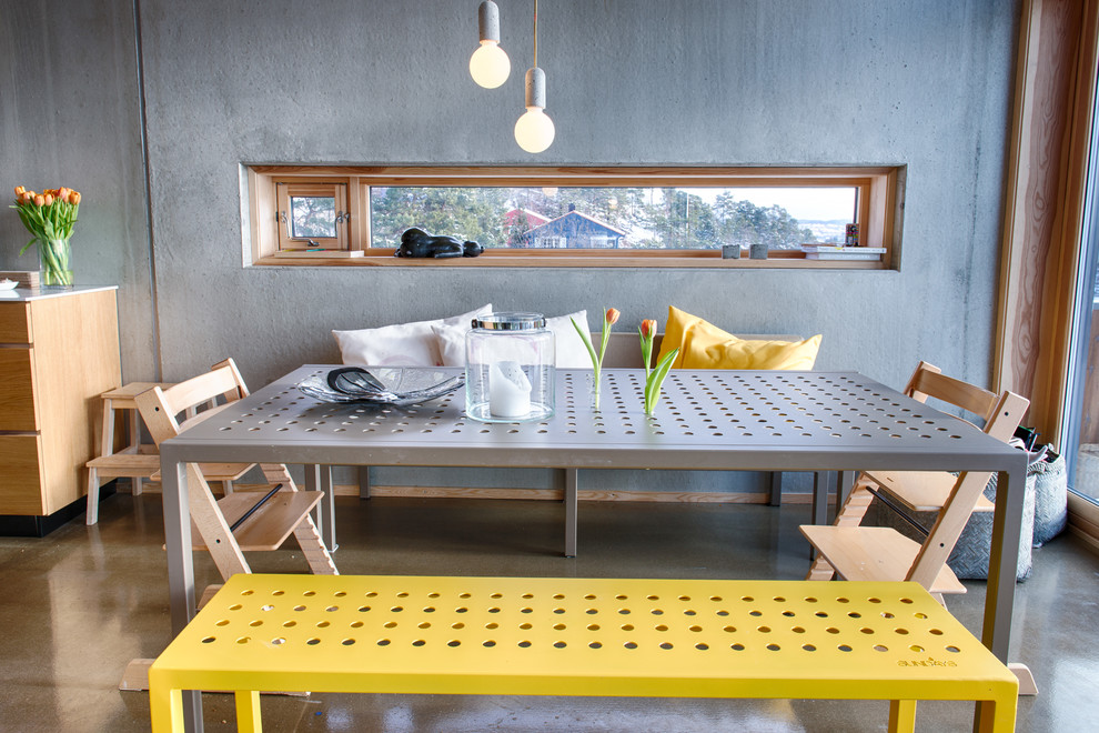 Photo of an urban dining room in Other with concrete flooring.