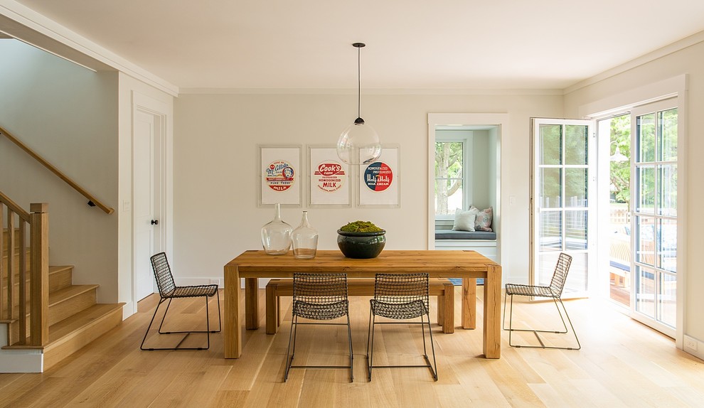 Photo of a medium sized classic dining room in Boston with white walls, medium hardwood flooring and brown floors.