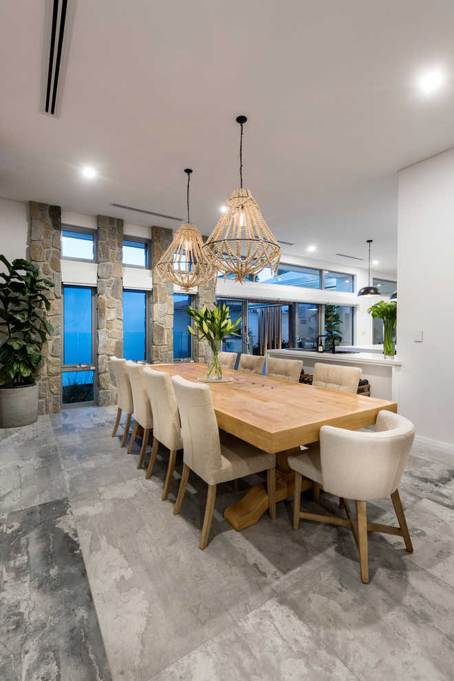Idee per una sala da pranzo aperta verso il soggiorno classica con pareti bianche e pavimento grigio