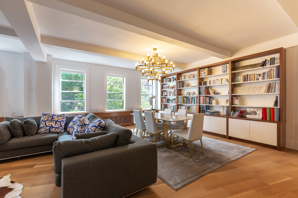 Design ideas for a contemporary dining room in New York with white walls, medium hardwood flooring and brown floors.