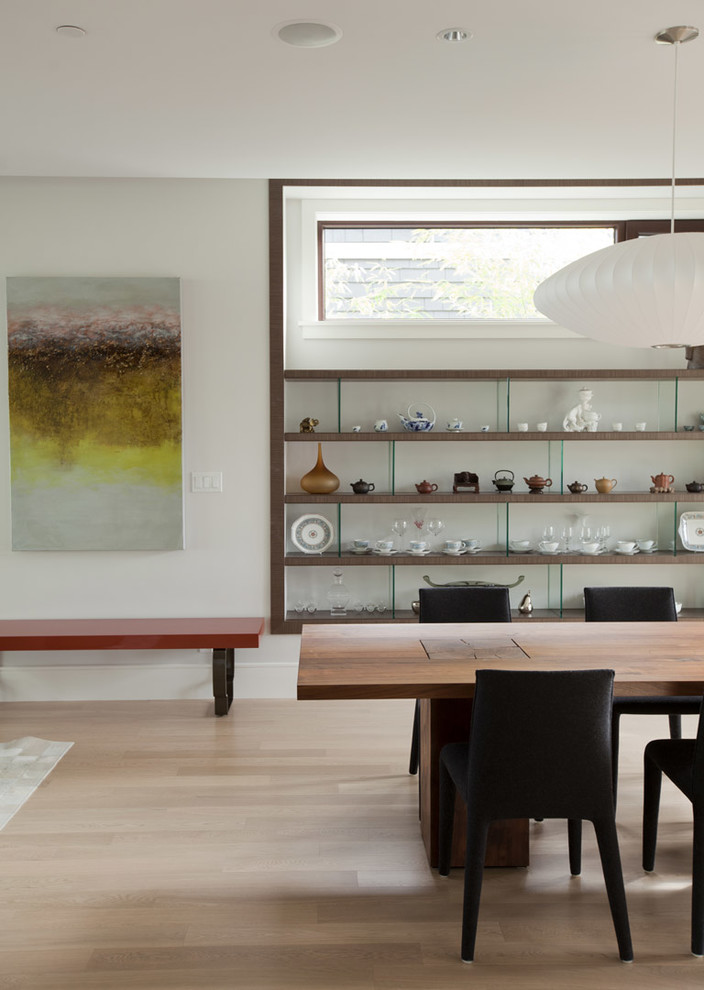 Photo of a contemporary dining room in Vancouver with white walls and light hardwood flooring.