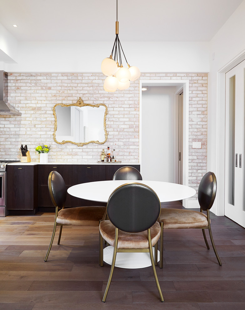 Photo of a small contemporary kitchen/dining room in New York with white walls and medium hardwood flooring.