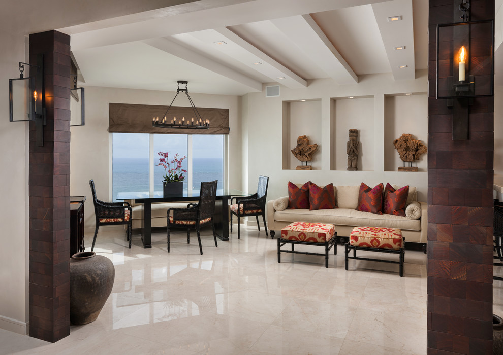 Photo of a large world-inspired open plan dining room in Miami with beige walls, marble flooring and beige floors.