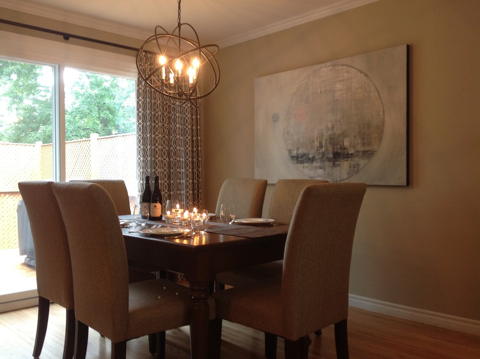 Mid-sized transitional light wood floor enclosed dining room photo in Montreal with beige walls