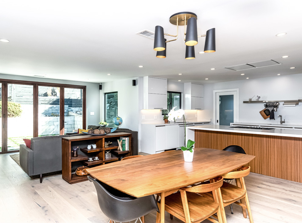 Foto di una sala da pranzo aperta verso la cucina design di medie dimensioni con pareti grigie, parquet chiaro e pavimento beige