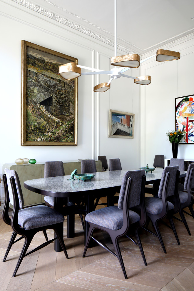 Medium sized traditional dining room in London with white walls, light hardwood flooring and beige floors.