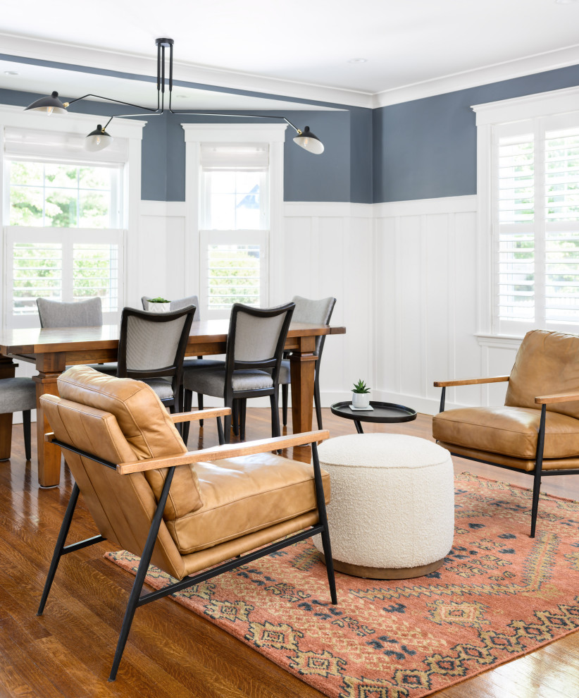 Kitchen/dining room combo - mid-sized transitional medium tone wood floor and wainscoting kitchen/dining room combo idea in Boston with blue walls