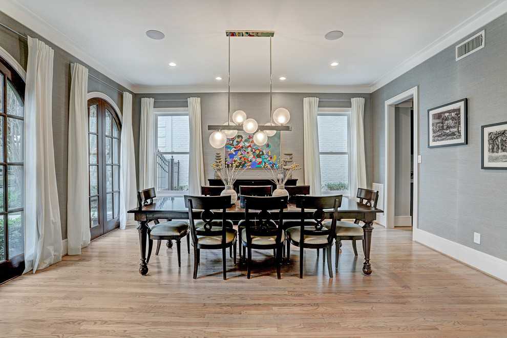 Inspiration for a large classic enclosed dining room in Houston with blue walls, light hardwood flooring and brown floors.