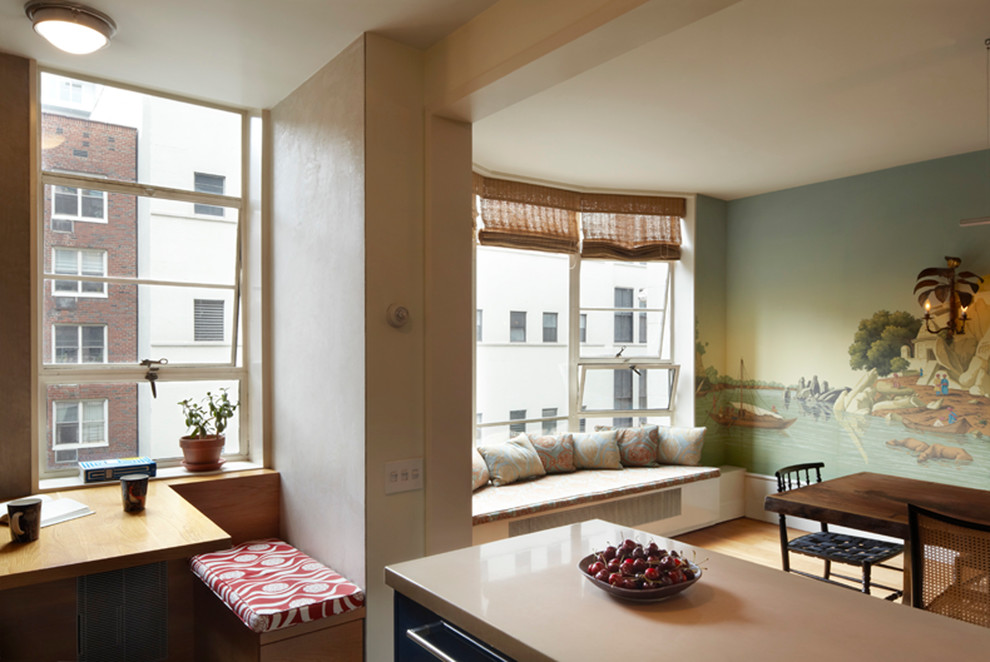 Example of a mid-sized transitional medium tone wood floor and brown floor kitchen/dining room combo design in New York with multicolored walls and no fireplace