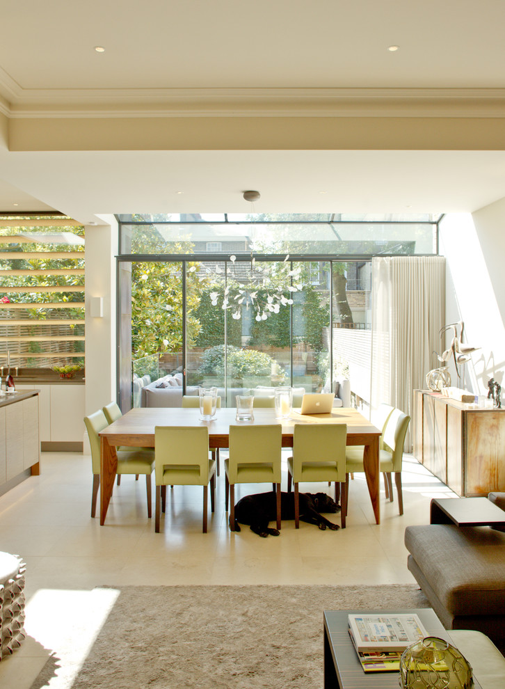 This is an example of a contemporary dining room in London with white walls.