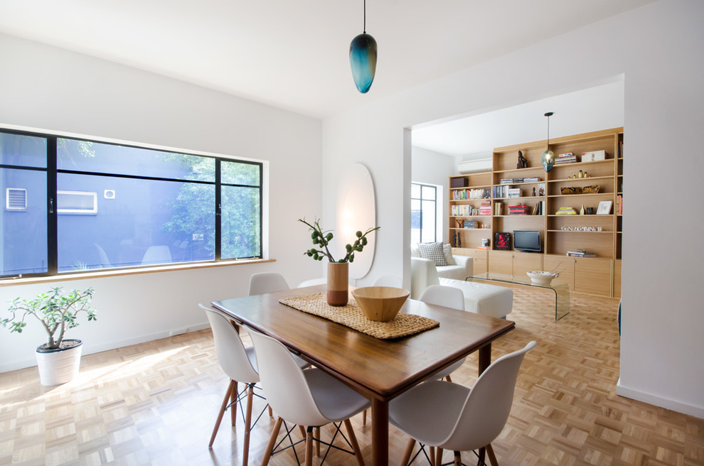 Large contemporary enclosed dining room in Melbourne with white walls, light hardwood flooring and no fireplace.