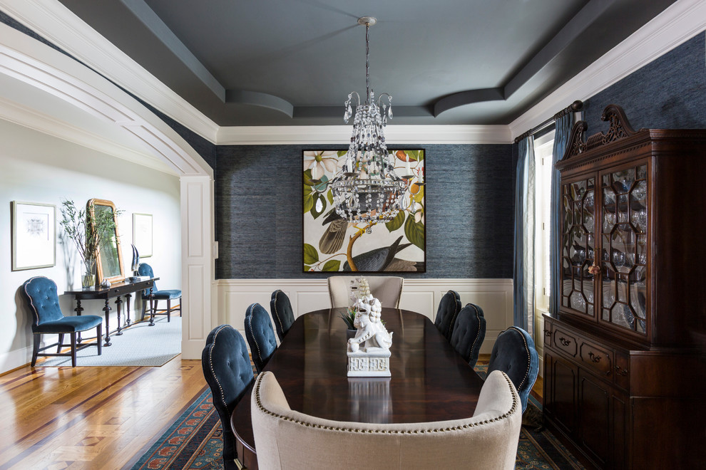 Example of a mid-sized classic medium tone wood floor and brown floor enclosed dining room design in Houston with gray walls and no fireplace