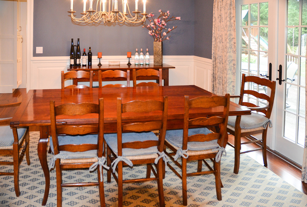 Mid-sized elegant medium tone wood floor enclosed dining room photo in New York with blue walls and no fireplace