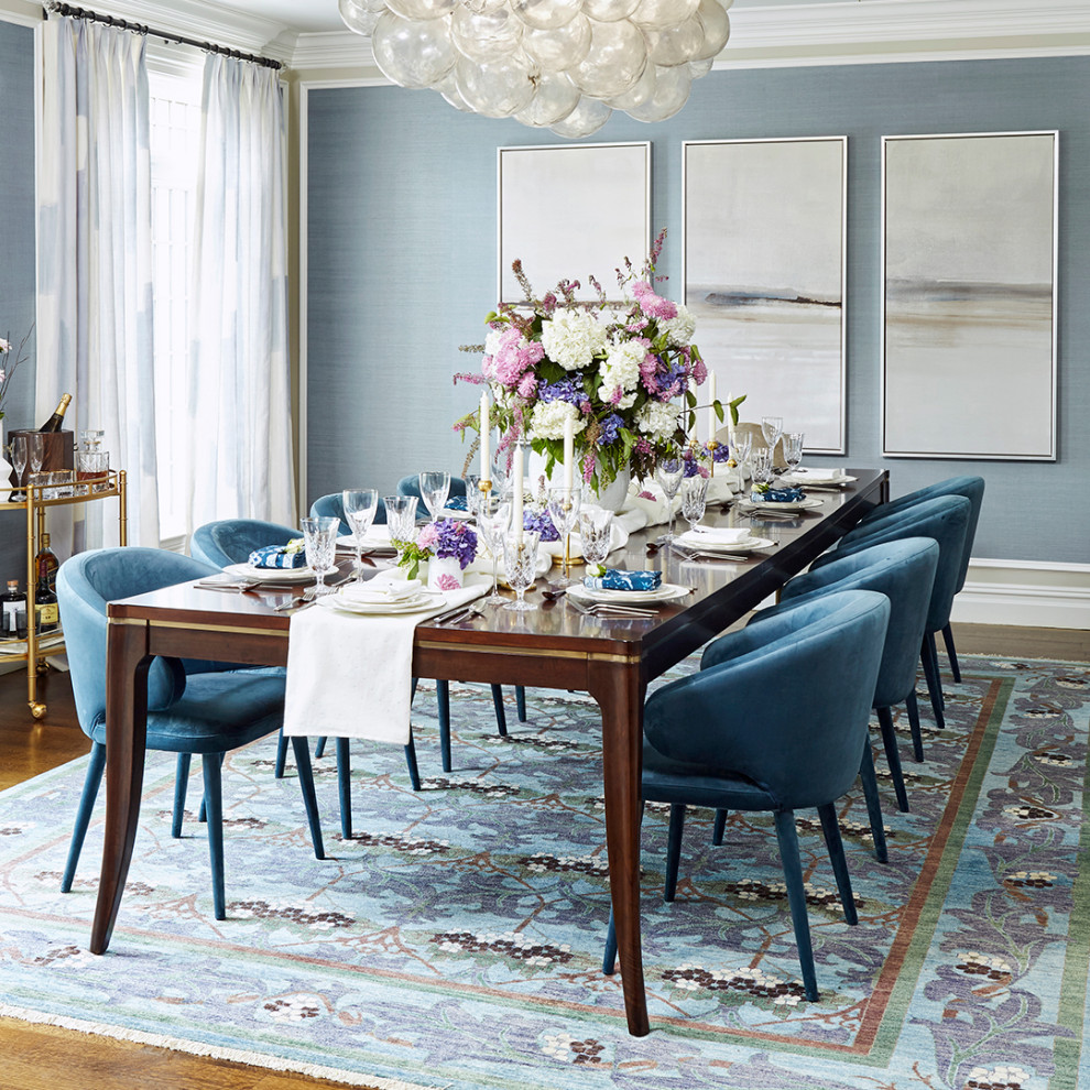 This is an example of a medium sized classic enclosed dining room in New York with blue walls, medium hardwood flooring, brown floors and wallpapered walls.