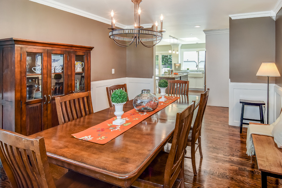 Medium sized classic kitchen/dining room in Newark with brown walls, medium hardwood flooring and brown floors.