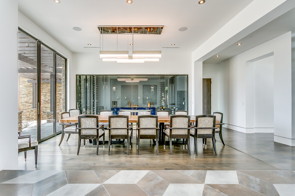 Idée de décoration pour une grande salle à manger design avec un mur blanc et un sol en bois brun.