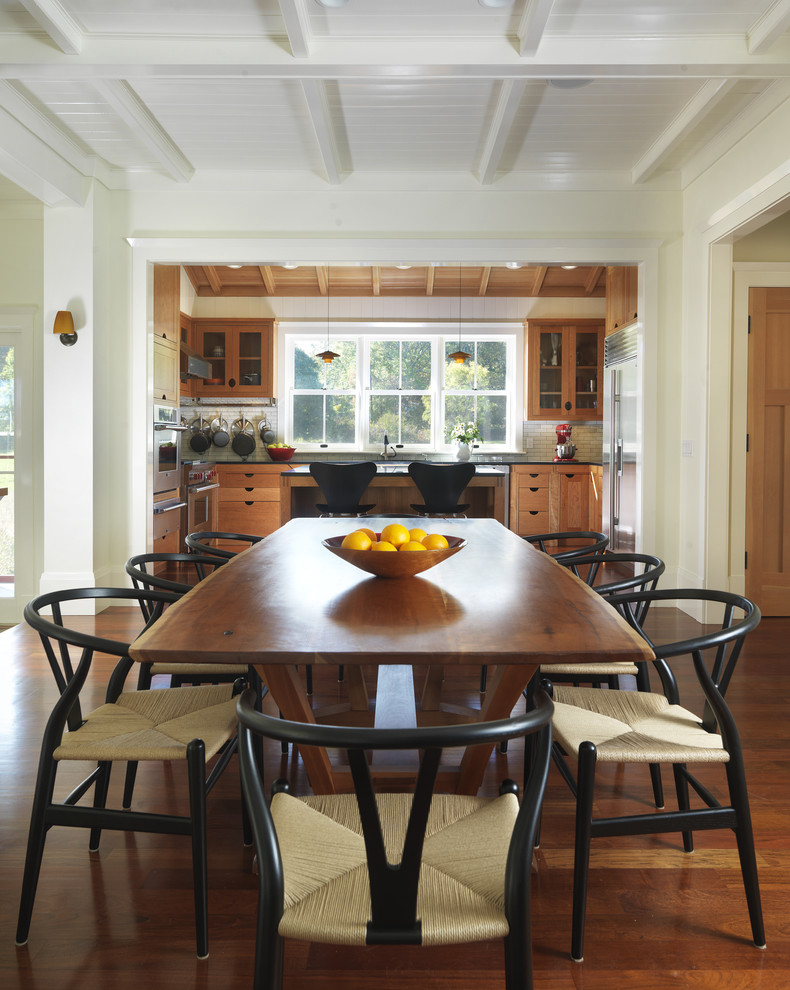 Immagine di una sala da pranzo aperta verso la cucina country con pareti beige e parquet scuro