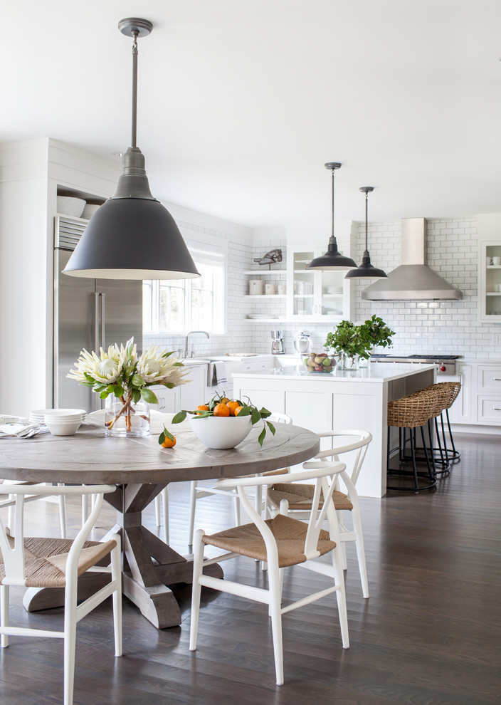 This is an example of an expansive traditional open plan dining room in New York with dark hardwood flooring.