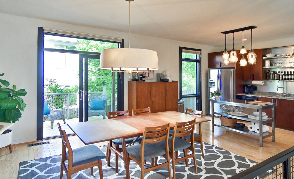 Photo of a medium sized modern kitchen/dining room in Atlanta with white walls and light hardwood flooring.