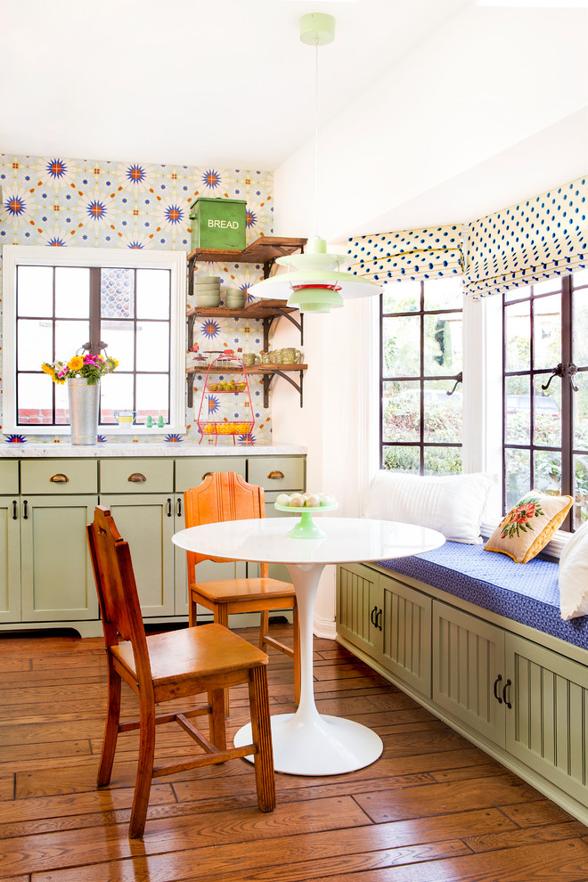 Kitchen/dining room combo - mid-sized cottage medium tone wood floor and brown floor kitchen/dining room combo idea in Los Angeles with white walls