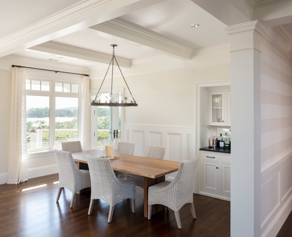 Photo of a medium sized beach style open plan dining room in Providence with beige walls, dark hardwood flooring, no fireplace and brown floors.
