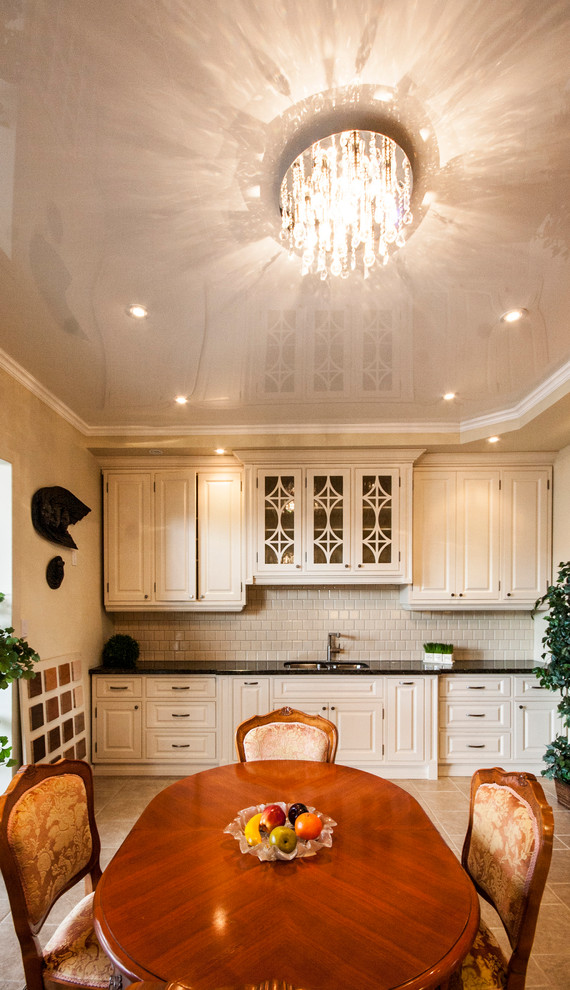 Large elegant porcelain tile kitchen/dining room combo photo in Toronto with beige walls