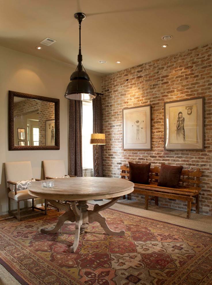 На фото: огромная отдельная столовая в классическом стиле с бежевыми стенами, коричневым полом и кирпичными стенами без камина