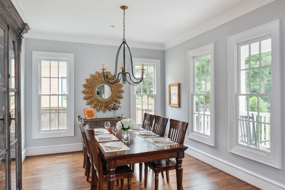 Enclosed dining room - mid-sized transitional medium tone wood floor and brown floor enclosed dining room idea in Houston with blue walls and no fireplace