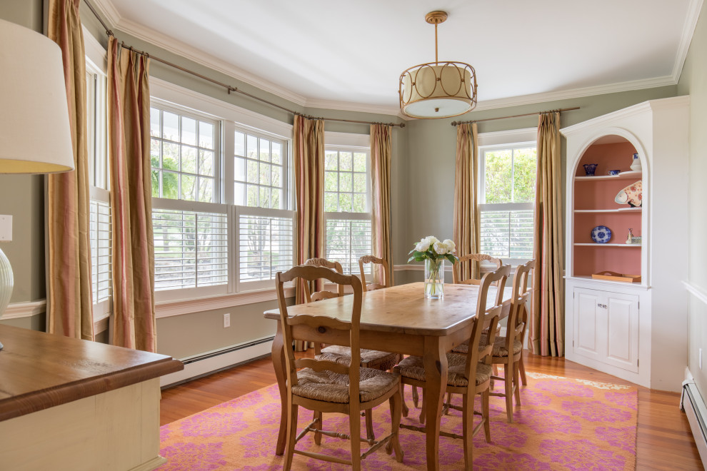 Design ideas for a traditional dining room in Boston with green walls, medium hardwood flooring and brown floors.