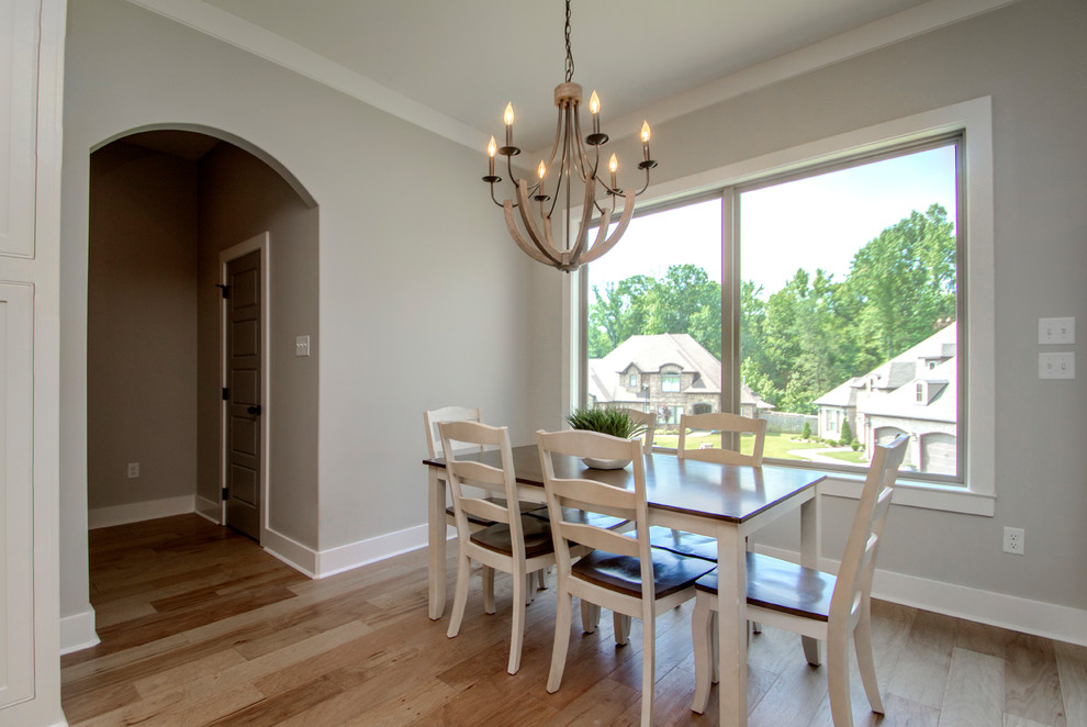 Example of a mid-sized transitional light wood floor and beige floor kitchen/dining room combo design in Little Rock with beige walls and no fireplace