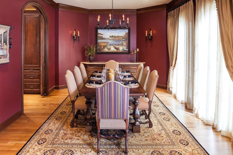 Medium sized classic enclosed dining room in Houston with red walls, medium hardwood flooring and no fireplace.