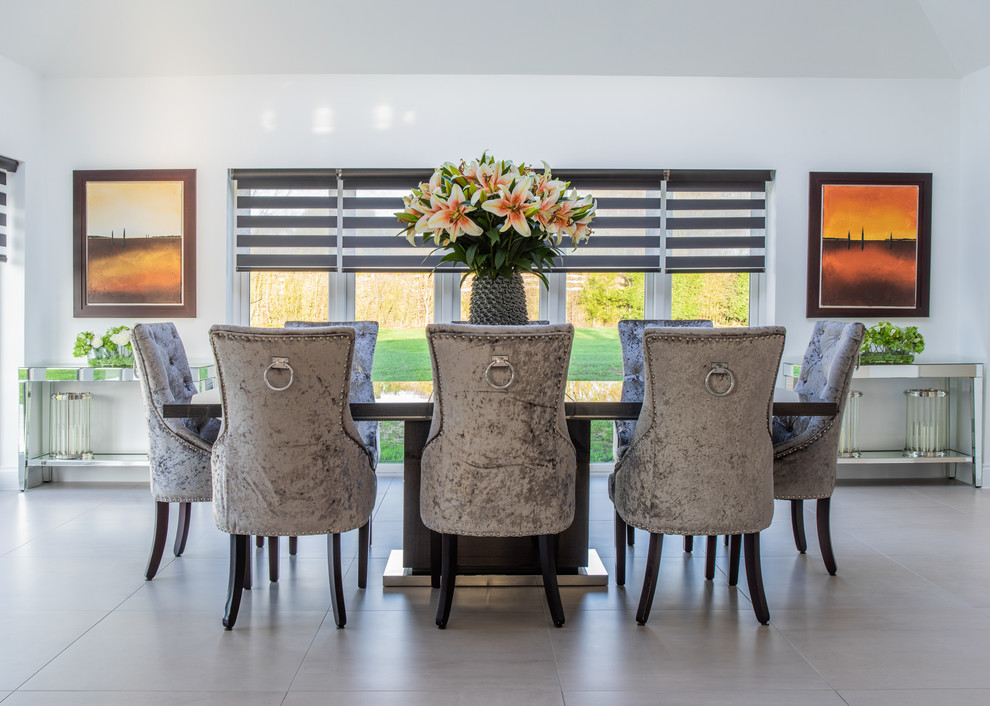 Inspiration for a contemporary gray floor dining room remodel in Kent with white walls