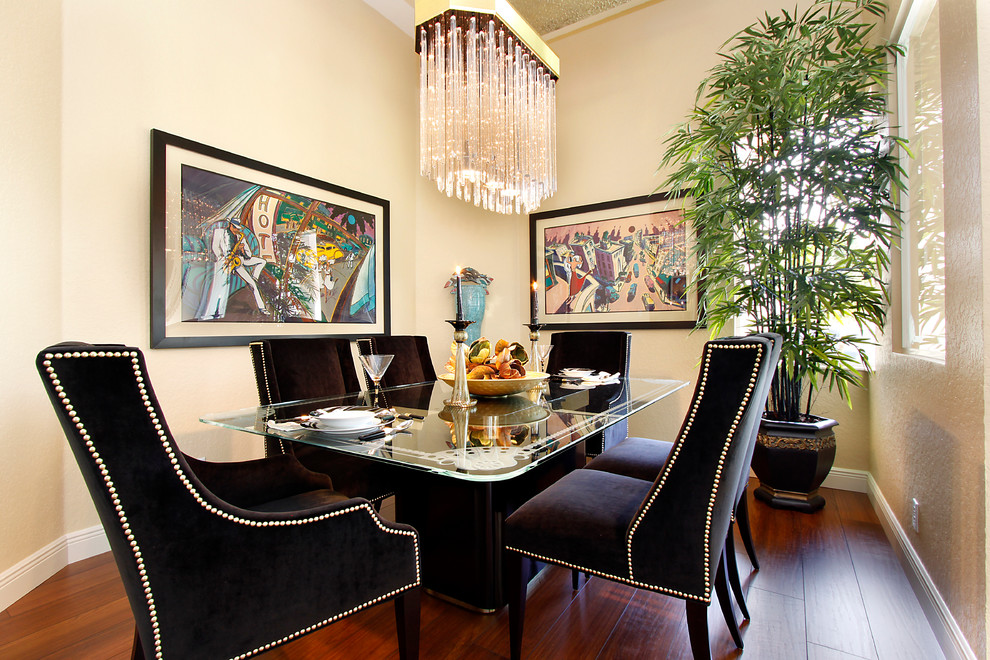 This is an example of a contemporary dining room in Miami with beige walls and dark hardwood flooring.